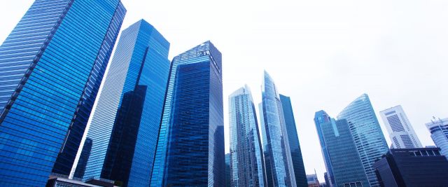 Stylised blue image showing several tall skyscrapers.