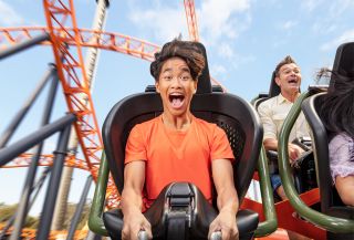Child riding the Steel Taipan rollercoaster