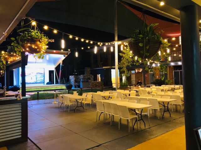 Outdoor area with tables and stage